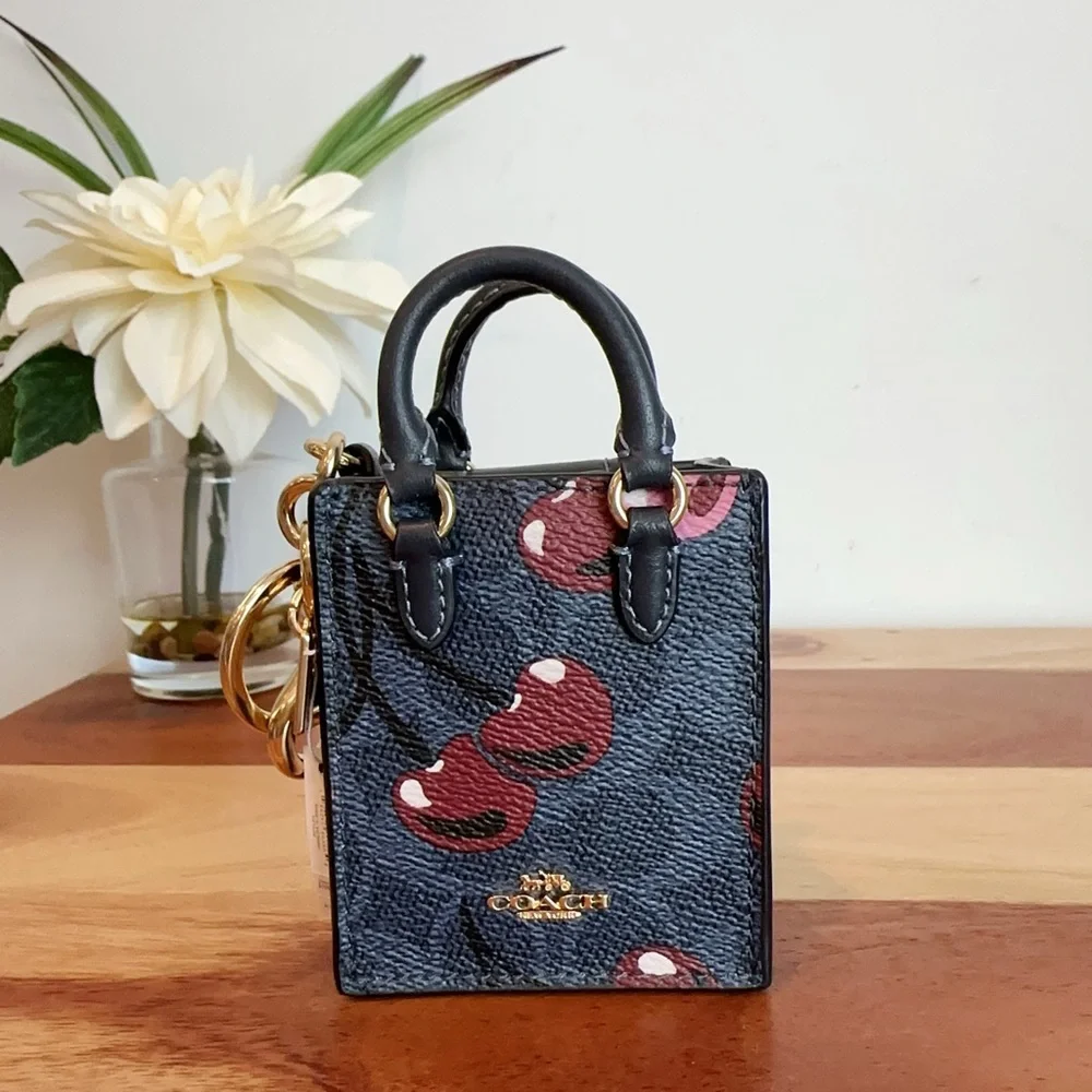 NWT Coach North /South Mini Tote Bag Charm In Signature Canvas With Cherry Print